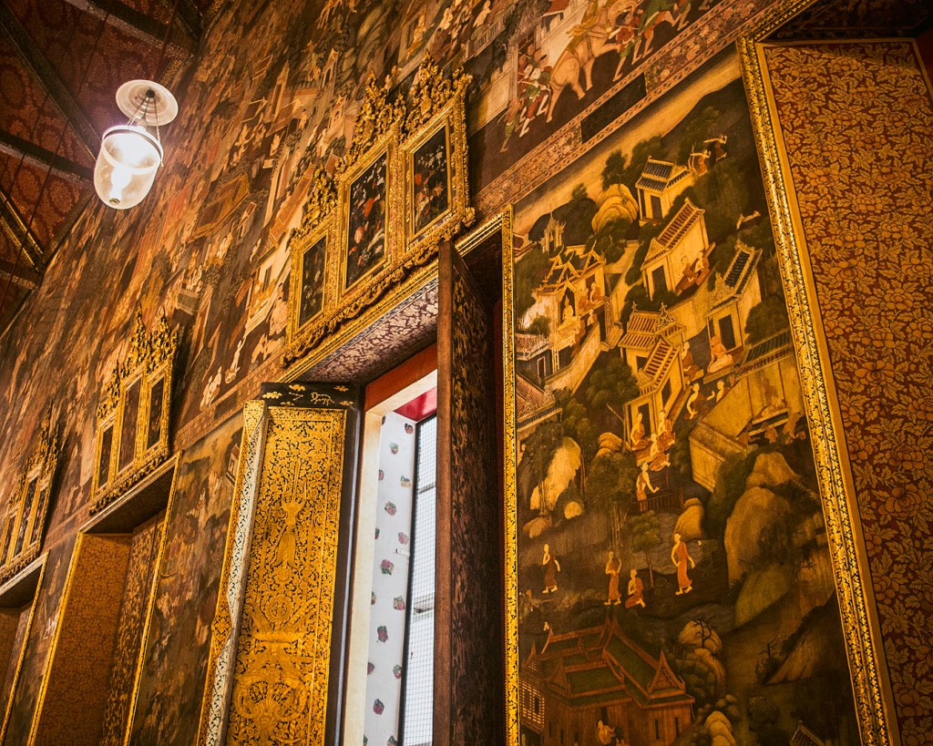 Paintings on the golden walls of the Temple of the Reclining Buddha