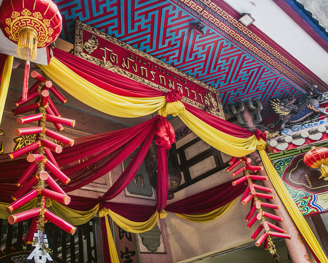 Colourful ribbons decorating a temple entrance in Bangkok's Chinatown.