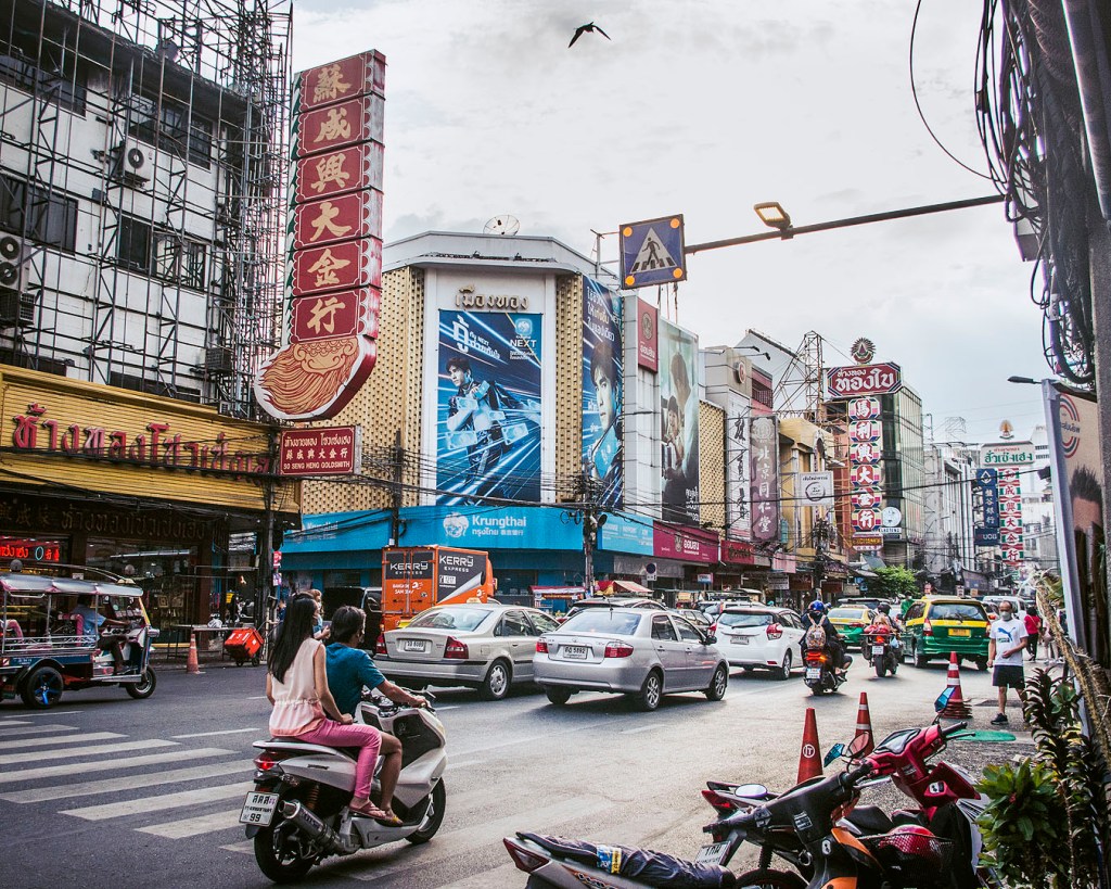 Cars, motorbikes and signs on Yaoworat Road in Bangkok's Chinatown.