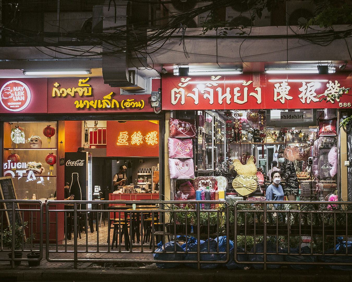 Shops lit up at night in Bangkok's Chinatown.