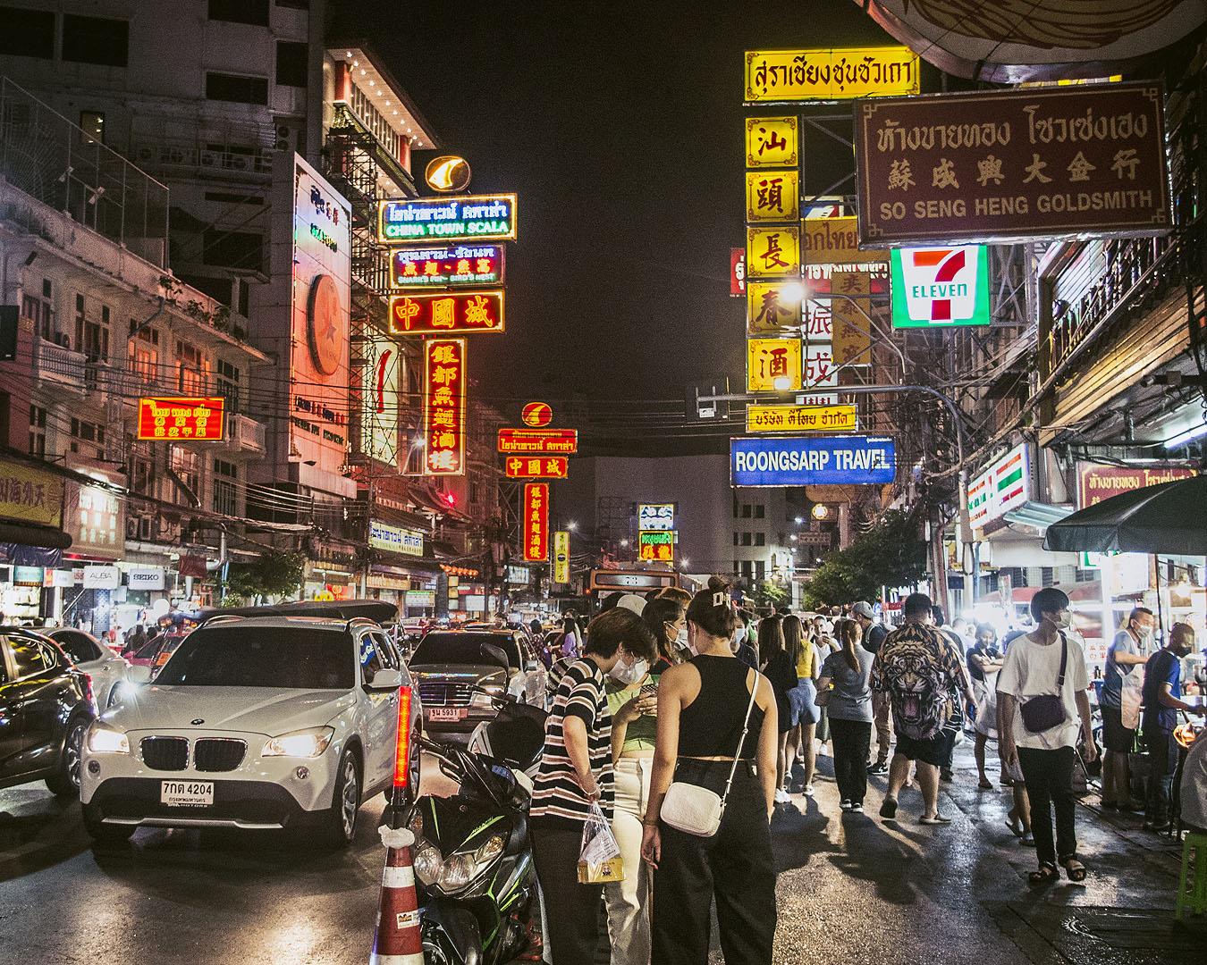 Neon signs and pedestrians on Yaoworat Road.