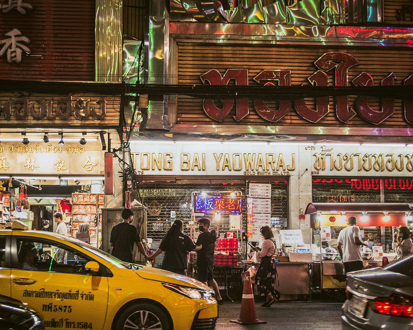 A taxi in front of shops in Bangkok's Chinatown.