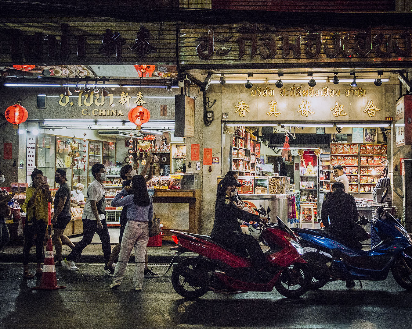 Shops lit up at night in Bangkok's Chinatown.