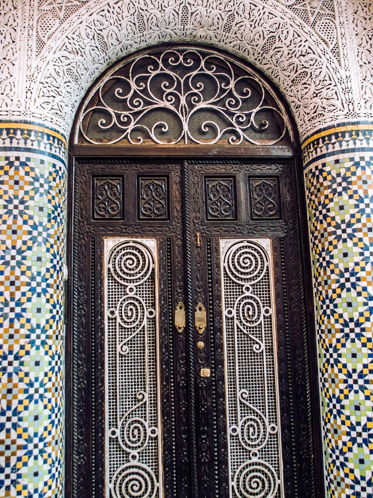 An arched door with traditional Moroccan tiles in Salé Medina.