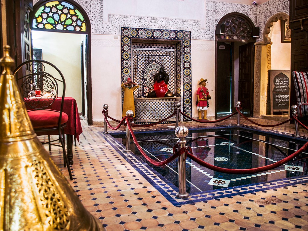 A pool and tiled floor in a traditional riad in Salé, Morocco.