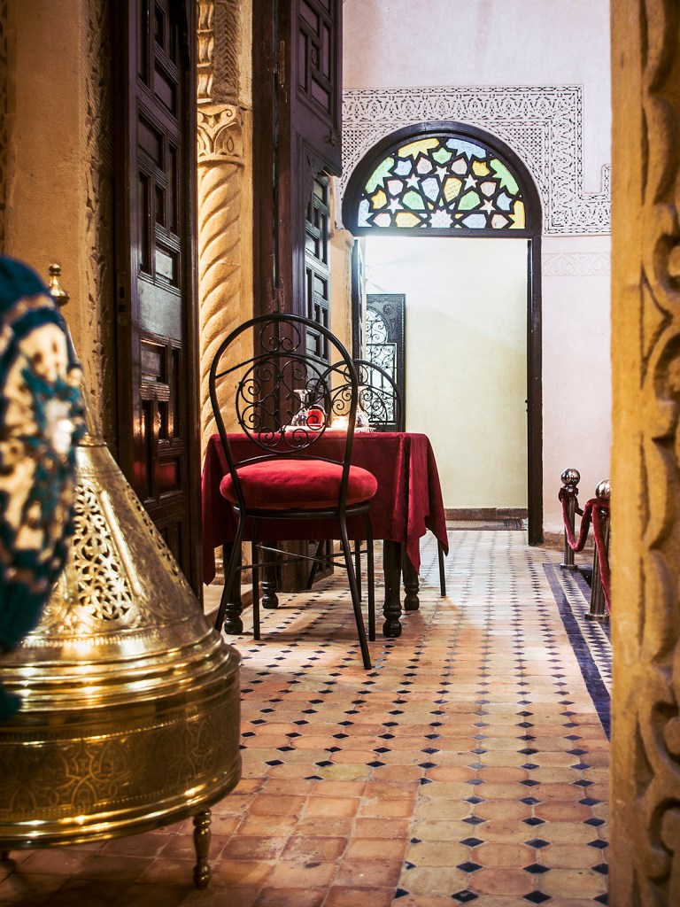 A table and doorway in a riad in Salé, Morocco.