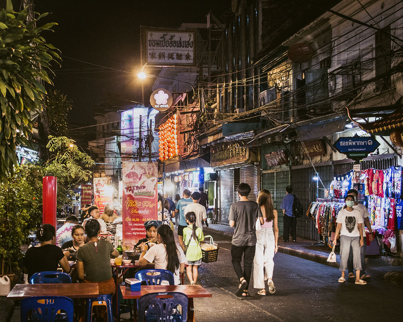 Pedestrians and diners in an alleyway in Bangkok's Chinatown.
