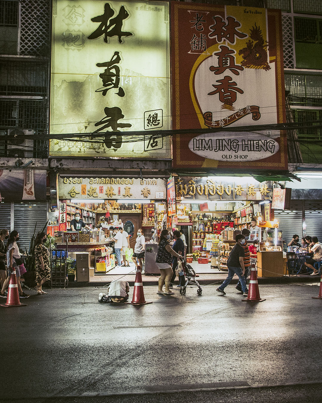 Shops lit up at night in Bangkok's Chinatown.