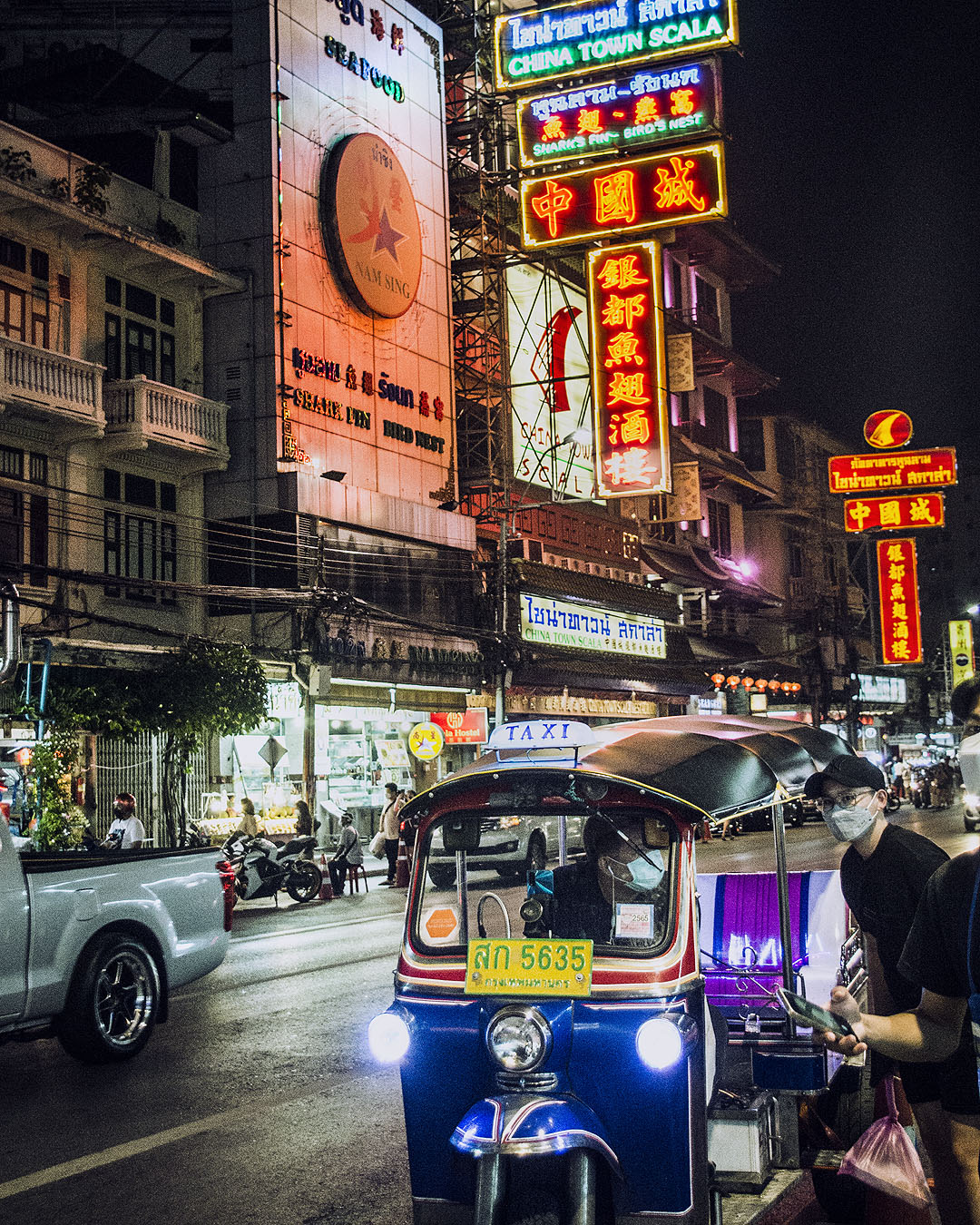 Neon signs lit up at night on Yaoworat Road.