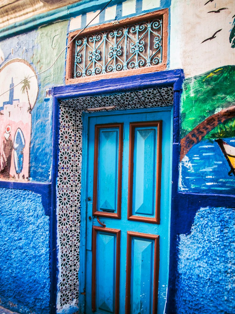 A blue door and street art in Salé, Morocco.