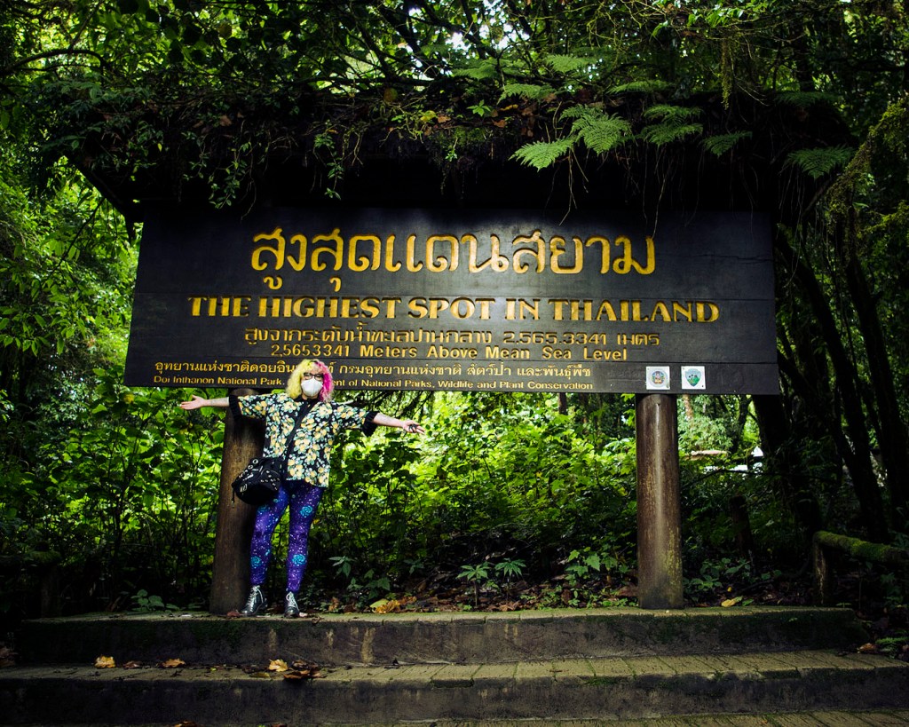 Me standing in front of a sign marking the highest spot in Thailand.