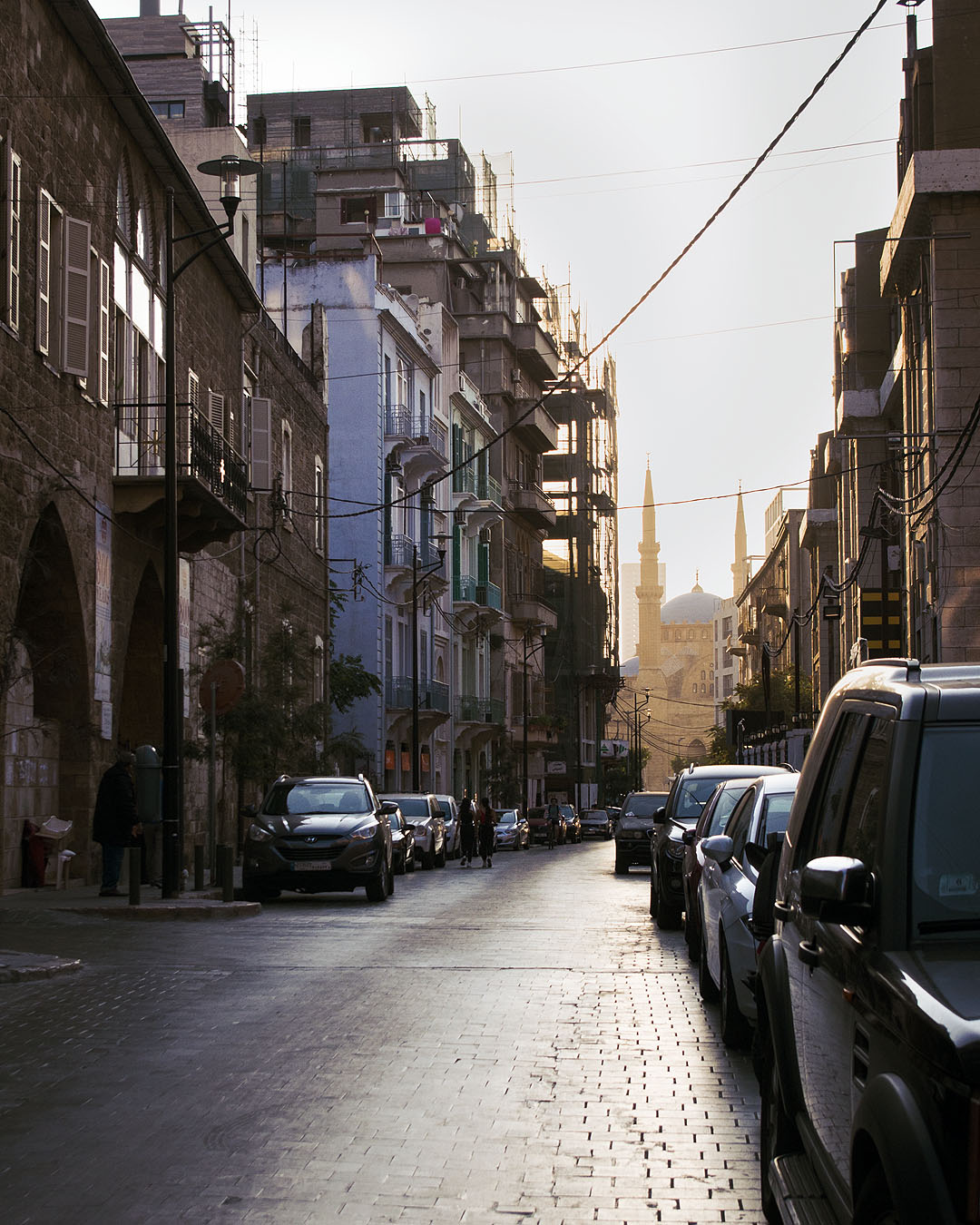 The Mohammed Al-Amin Mosque viewed through buildings on Gouraud Street at golden hour.
