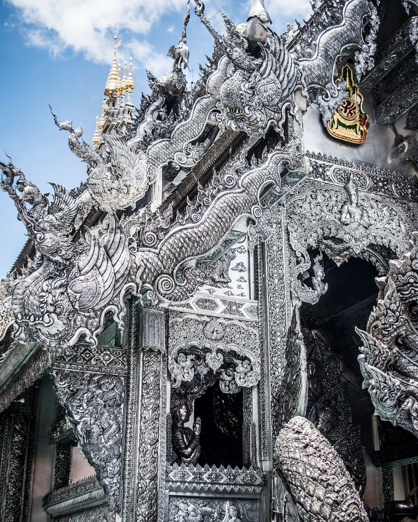 A close-up of the delicate silver carvings on the frontage of the shrine at Wat Sri Suphan.