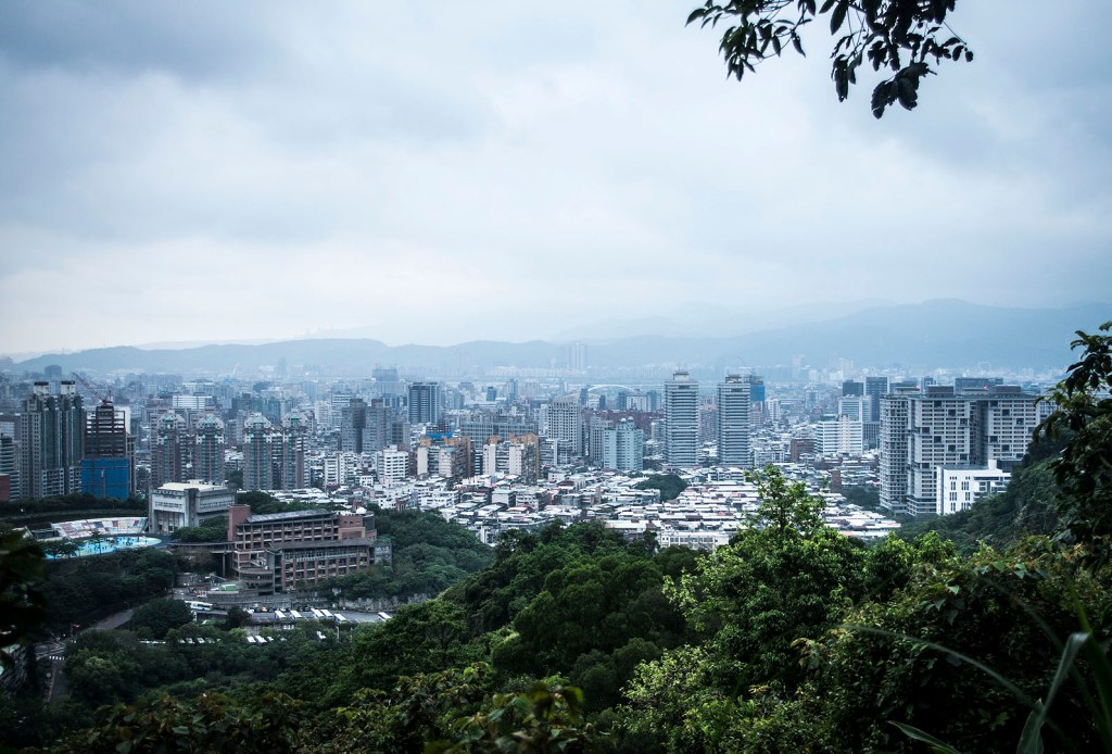 The view of buildings in eastern Taipei and distant mountains from Leopard Mountain.