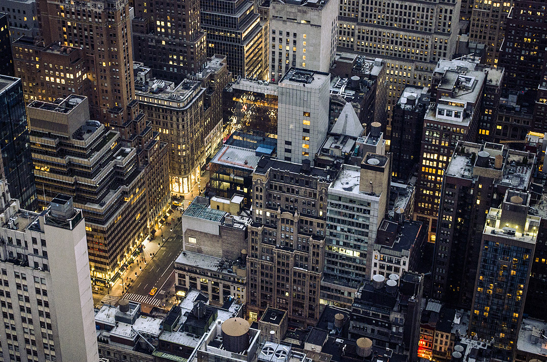The rooftops of illuminated skyscrapers in New York City, viewed from Top of the Rock.