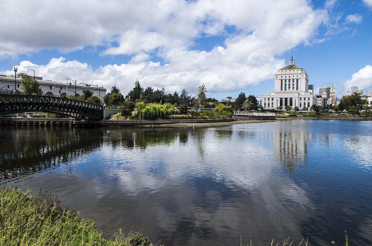 A cloudy blue sky reflected in Lake Merritt in Oakland.