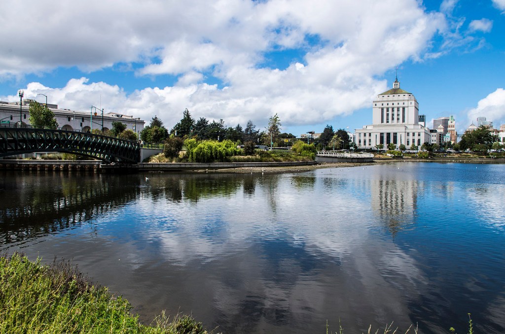 A cloudy blue sky reflected in Lake Merritt in Oakland.